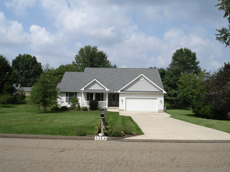 Exterior of white single family home with large lawn