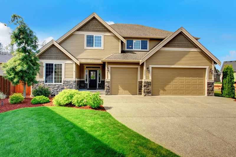 Exterior of beige single family home with 3 car garage