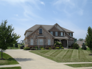 Exterior of large home with faux stone siding